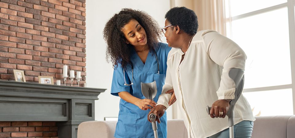 A caregiver attending to a senior at home